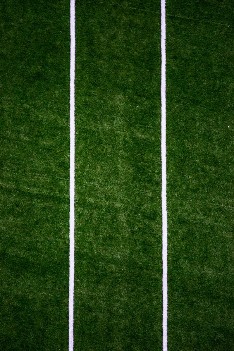 a man standing on top of a lush green field